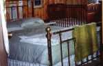 The relaxing Heritage Room features a queen-size brass bed and private balcony